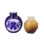 A Chinese carved agate snuff bottle and one other in glass, (stoppers lacking), former 4 cm high