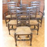 A set of six late 20th Century oak rush-seat ladder back dining chairs, including two carvers, 95 cm
