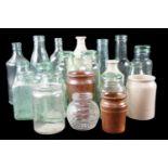 A quantity of Victorian and early 20th Century glass bottles, domestic preserve jars, stoneware