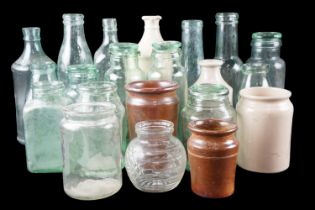 A quantity of Victorian and early 20th Century glass bottles, domestic preserve jars, stoneware