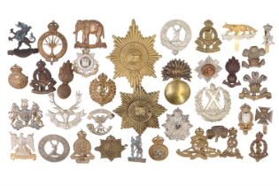 A varied group of British army cap badges etc