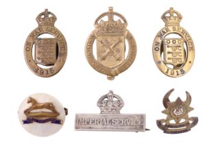 A Great War Imperial Service badge, three munitions workers' lapel badges, a West Yorkshire Regiment