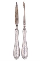 Two Edwardian silver-handled manicure tools, decorated with bright-cut foliate scrolls, and engraved
