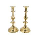 A pair of Victorian brass push-eject candlesticks, having pronounced baluster knops, 24 cm