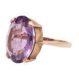 An amethyst dress ring, the 16 x 12 mm oval brilliant claw set on a closed gallery between