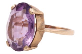 An amethyst dress ring, the 16 x 12 mm oval brilliant claw set on a closed gallery between