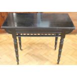 A Victorian ebonised turnover top games table, 91.5 x 45.5 x 73 cm