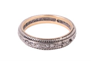 A diamond eternity ring, the old cut diamonds line set in precious white metal between rope