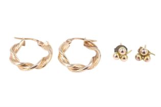 Two pairs of 9 ct gold earrings comprising shamrock studs and a pair of bine-twist hoops, hoops 18