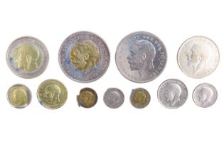 A group of George V silver coins, including two crowns, two half crowns, two one shillings, etc
