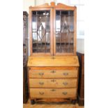 A late Regency provincial mahogany and satinwood bureau bookcase, having geometric ebony