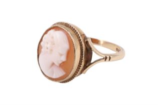 A shell cameo finger ring, comprising an oval cameo depicting a young lady, bezel set having a