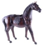 A large early 20th Century leather horse, having glass eyes, in the style of Dimitri Omersa, 48 x 22