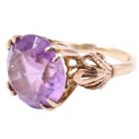 An ornate amethyst dress ring, the 12 mm brilliant set on a lancet gallery with four bifurcated