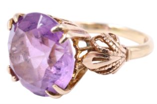 An ornate amethyst dress ring, the 12 mm brilliant set on a lancet gallery with four bifurcated