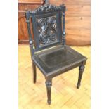 A Victorian carved and ebonised stand chair, 98 cm high