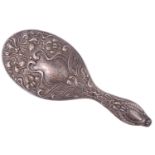 An early Edwardian silver hand mirror, having scrolling and floral repoussé decoration and a