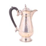 A George V silver hot water jug, of baluster form and having a scroll handle, Fattorini & Sons