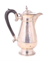 A George V silver hot water jug, of baluster form and having a scroll handle, Fattorini & Sons
