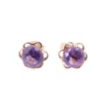 A pair of amethyst stud earrings, each having a 6.5 mm brilliant set on an openwork lobed back,