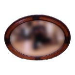 A George V oak framed oval mirror, 90 x 65 cm