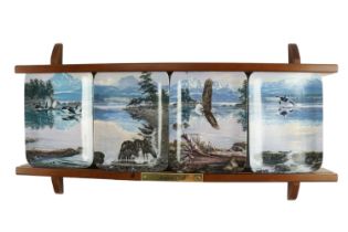 A set of four limited edition collector's plates, "Dawn's Call", together with a plate rack and