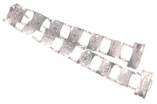 An Edwardian silver belt, comprising 13 pierced and engraved panels with adorsed scrolling floral