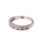 A late 20th Century diamond half hoop eternity ring, having nine brilliants, in pavé millegrain