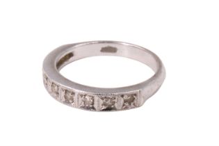 A late 20th Century diamond half hoop eternity ring, having nine brilliants, in pavé millegrain