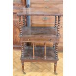 A Victorian rosewood whatnot, having tapering bine-twist supports and a drawer to the central shelf,