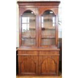 A William IV glazed mahogany cabinet bookcase, having tooled leather shelf aprons, 130 x 53 x 224