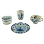 Four items of Delft blue-and-white ceramics, comprising a beaker, a square mug, a saucer, and a