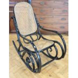 A late 20th Century ebonised bentwood and cane rocking chair