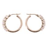 A pair of late 20th Century five stone goshenite cuff earrings, having a line of 0.25 carat beryl