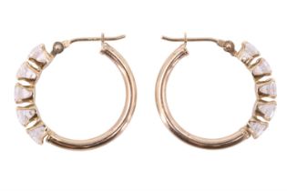 A pair of late 20th Century five stone goshenite cuff earrings, having a line of 0.25 carat beryl