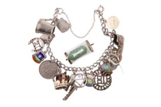 A vintage white metal charm bracelet together with a rolled £1 banknote charm