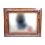 A rectangular wall mirror in decorative wooden moulded frame, circa 1920s, 66 cm x 87 cm