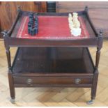 A late 20th Century mahogany games table, on turned supports with an under-shelf having two drawers,