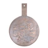 A Japanese bronze hand mirror, relief decorated with garden scenes within geometric reserves and