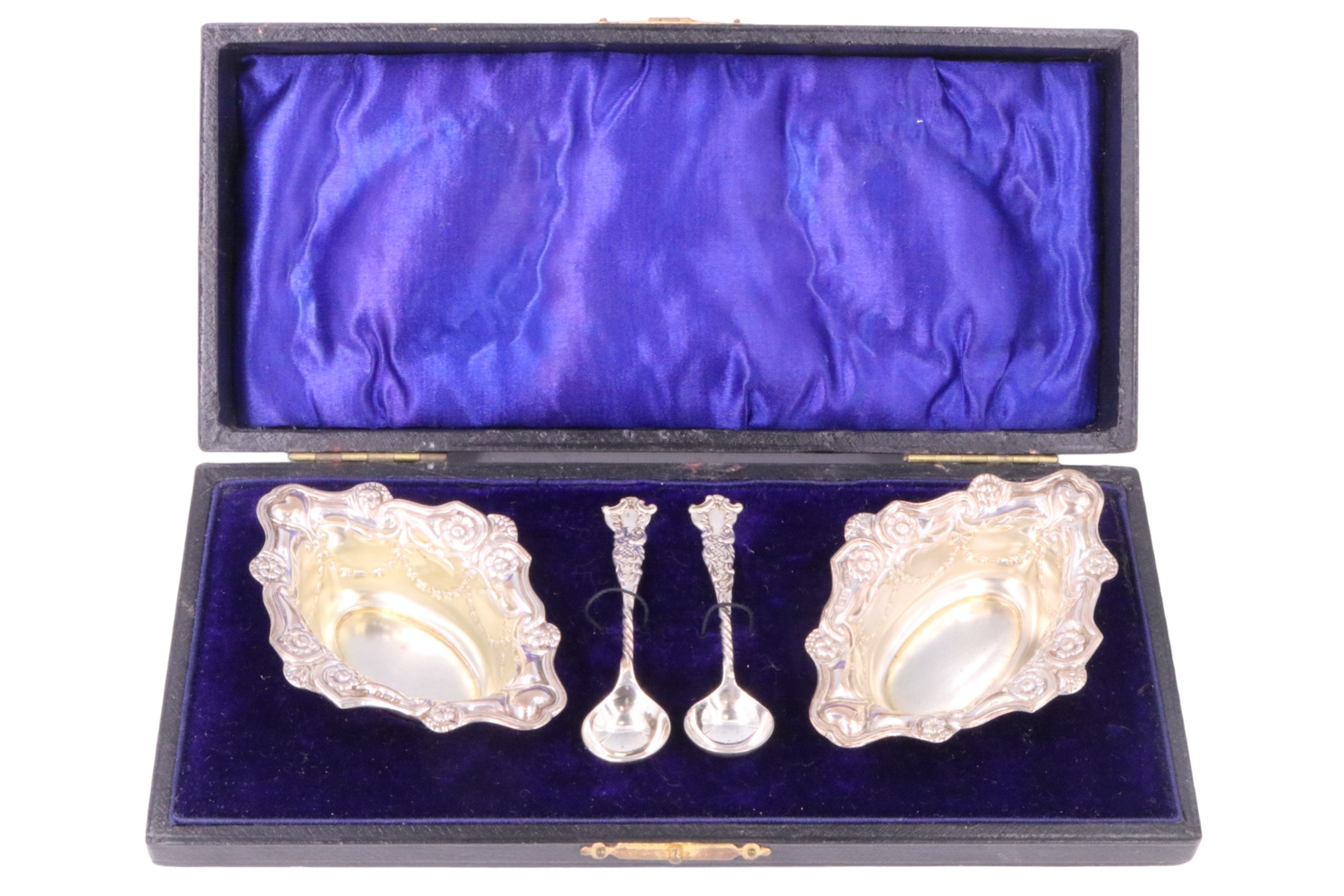 A cased pair of Edwardian silver salt cellars, having embossed decoration, associated spoons, - Image 6 of 6