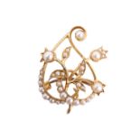 A Belle Époque seed pearl brooch, having 15 ct yellow metal scrolling floral openwork, accentuated