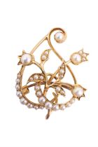 A Belle Époque seed pearl brooch, having 15 ct yellow metal scrolling floral openwork, accentuated