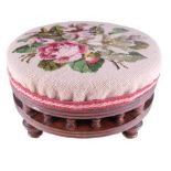 A Victorian tapestry upholstered walnut footstool, having a spindle gallery base, 30 x 16 cm