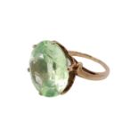 An imposing pale green quartz solitaire ring, the 12 carat brilliant set in a pierced gallery