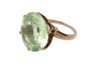 An imposing pale green quartz solitaire ring, the 12 carat brilliant set in a pierced gallery