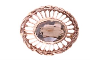 An early 20th Century citrine and 9 ct yellow metal brooch, the 10 x 14 mm oval brilliant bezel