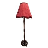 A mid-to-late 20th Century stained sycamore standard lamp, 146 cm to top of bayonet fitting
