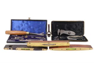 Two cased sets of draughtsman's instruments together with two brass-faced spirit levels, one