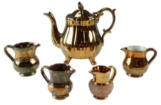 A Victorian copper lusterware teapot together with four jugs, former 17 cm