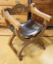 A contemporary carved oak and hide seated X-frame stool, 75 cm high